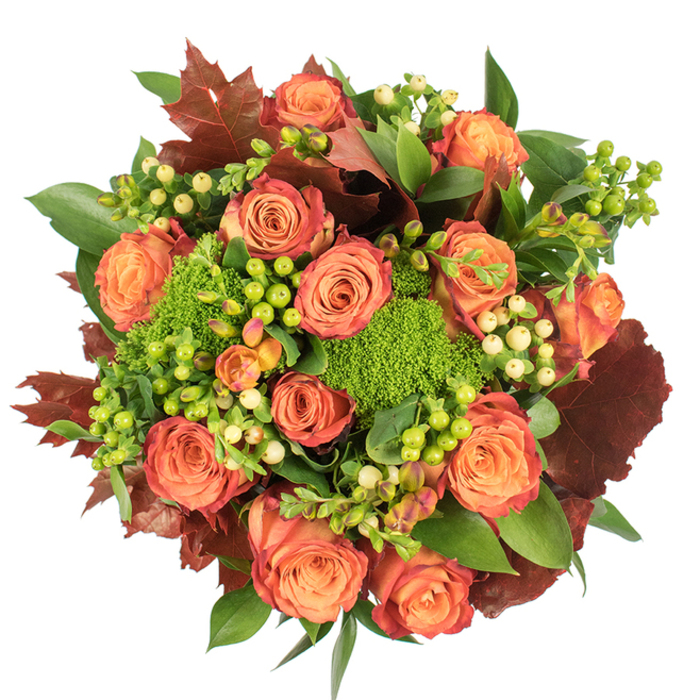 Top-down, against a clean white surface, this autumn-inspired bouquet presents a generous, circular composition that celebrates texture and warm colour. A profusion of fully open roses anchors the design-each blossom moving from a soft peach heart through coral into saturated orange, sometimes with outer petals edged in a rusty red that calls to mind Stepney's brickwork at dusk. Interspersed among the roses are clusters of Hypericum berries: some a bright lime, others a pale cream, their glossy beads offering crisp highlights and tactile contrast. Plush green trick dianthus sits like tiny cushiony mounds among the blooms, adding a verdant, mossy texture that feels unexpectedly modern against the classic roses. Deep green foliage provides volume and shine, while larger, lobed leaves in burgundy and burnt orange are placed strategically to give the arrangement a grounded, autumnal silhouette. Light skims the bouquet's surface, revealing velvety petal textures and casting soft shadows between layers of foliage, enhancing depth and movement. Designed with the same care we use in our Stepney studio near Mile End Park, this piece suits a Thanksgiving table, seasonal home styling, or a warm gift for someone settling into a new flat on Commercial Road. As you smell it, the bouquet offers a gentle rose perfume threaded with greener, earthy notes-the olfactory echo of a crisp walk through an East London park in late October. Flowers Stepney prepares this style for local delivery on request.
