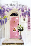 This scene shows a sunlit Stepney entrance that feels like a quiet celebration of moving in, the sort of doorway you might notice while wandering between Stepney Green and the surrounding terraces. A softly painted pink door takes centre place, its tone somewhere between blush and rose, and it's framed by clean white walls that seem to drink in the light. Above and around the door, wisteria hangs in generous cascades, draped like nature's own bunting. The blooms are a dreamy lavender and lilac mix, falling in long, tumbling clusters, suggesting a gentle fragrance that would float across the small front garden and out towards the pavement. The pink shutter beside the door continues the pastel theme, giving the façade a harmonious, almost storybook charm. Just at the doorstep, on the stone step worn smooth by years of comings and goings, sits a vintage-style grey bucket pressed into service as a vase. It overflows with white and cream roses, their petals soft and full, arranged with a florist's practiced touch alongside muted green foliage that adds depth and movement. A delicate pink ribbon is tied around the bucket, the bow's satin sheen catching small glints of sunlight that filter through the wisteria. Shadows form gentle patterns over the door and step, creating a feeling of privacy and sanctuary despite the urban setting. The overall mood is tender and optimistic, perfect for marking the joy of a new address in Stepney-a floral gesture that seems to bless the threshold with warmth, good fortune, and the comforting sense that this place is ready to become a true home.